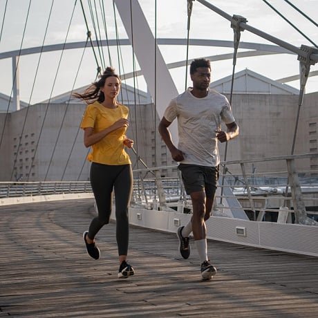 kobieta i mężczyzna biegnący w koszulkach i butach do biegania